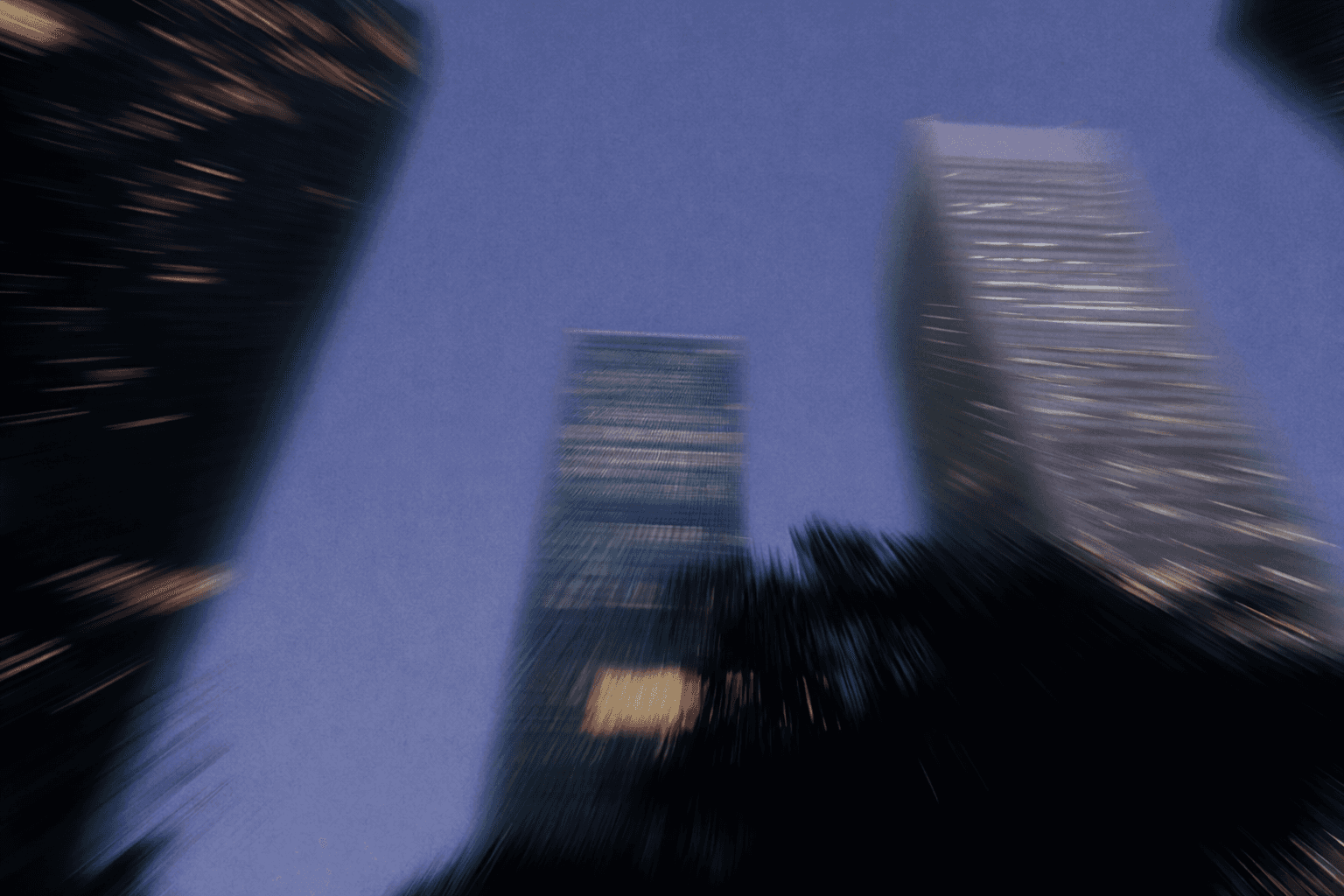 woman holding a phone and man looking at the phone. both are smiling