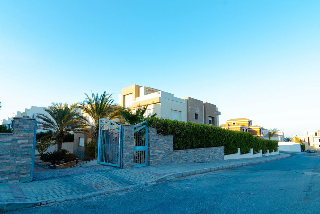 brown wooden house with green grass field