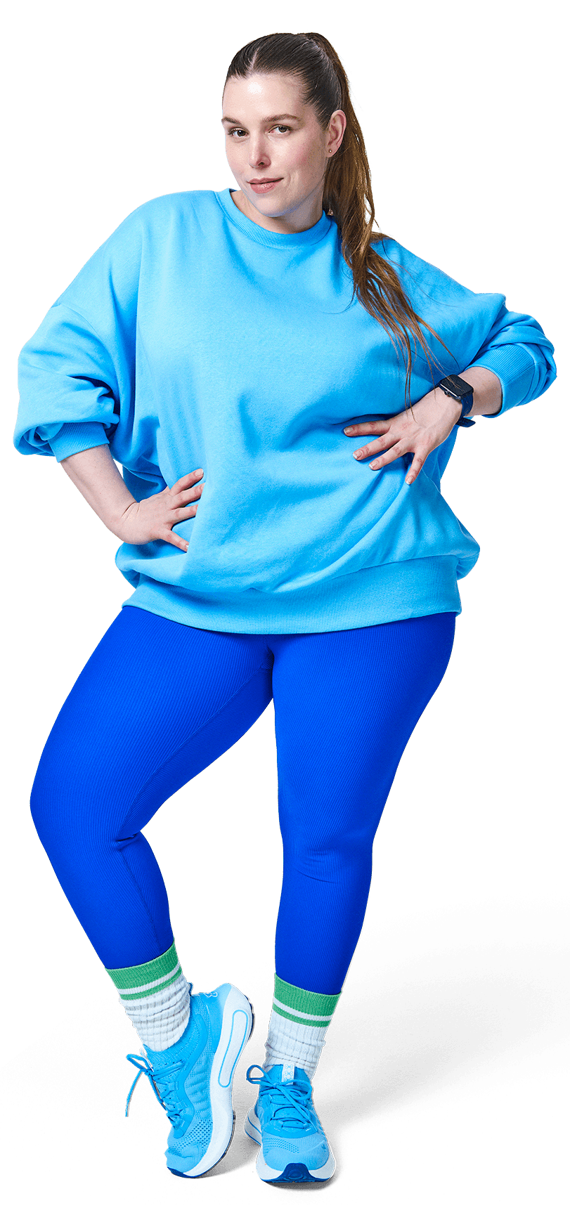 A person in a blue outfit is standing joyfully, with hands on hips and a playful expression.