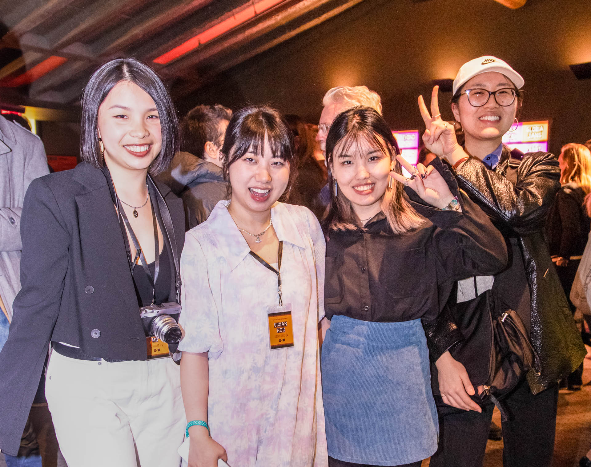 a group of students smiling for the camera in the SVA Theatre lobby after the Venture Forum