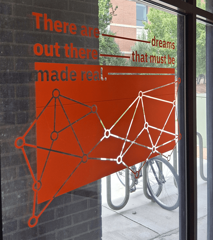 Closeup picture of the vinyl piece hung up on the window.