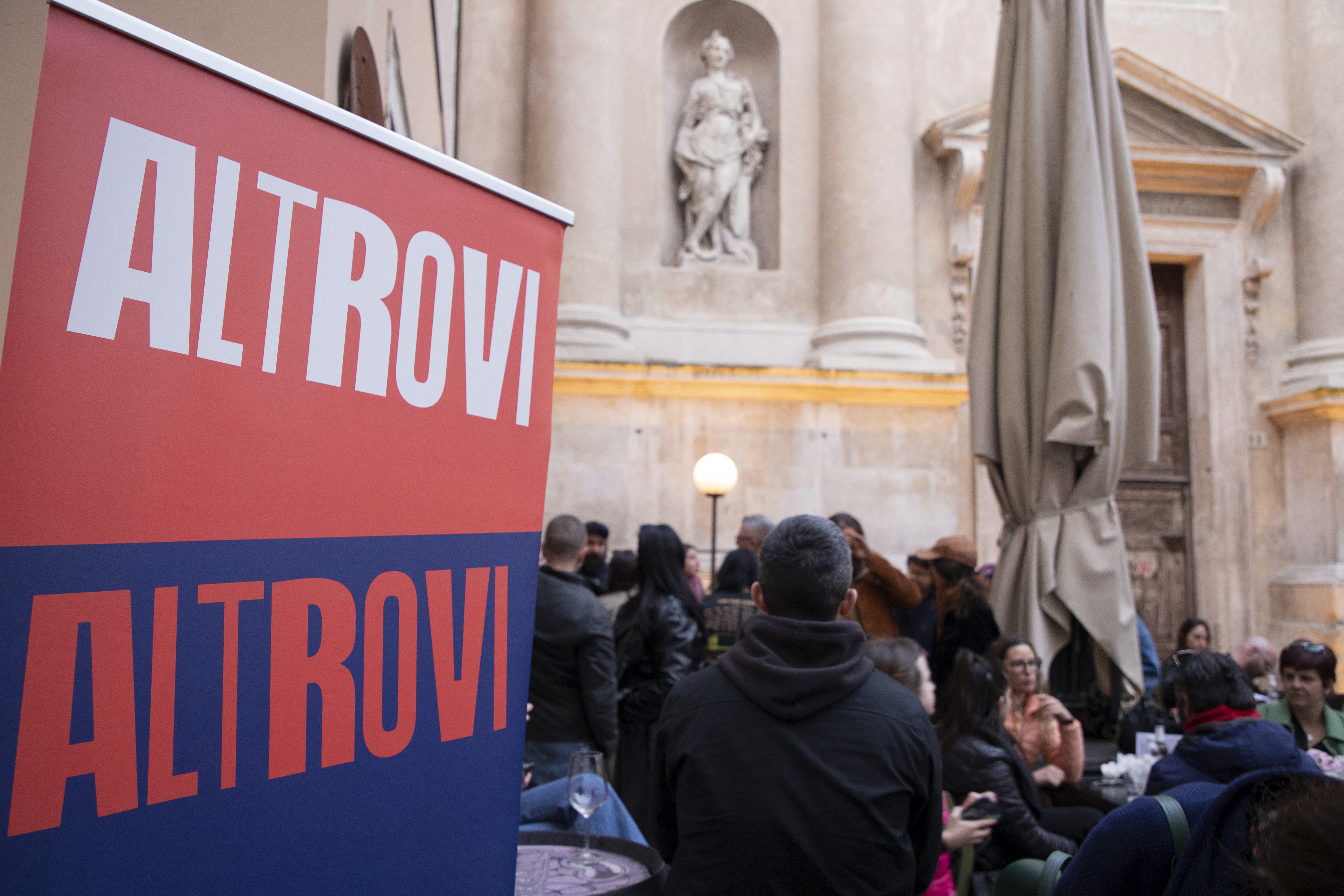 Smiling woman in feathered carnival costume