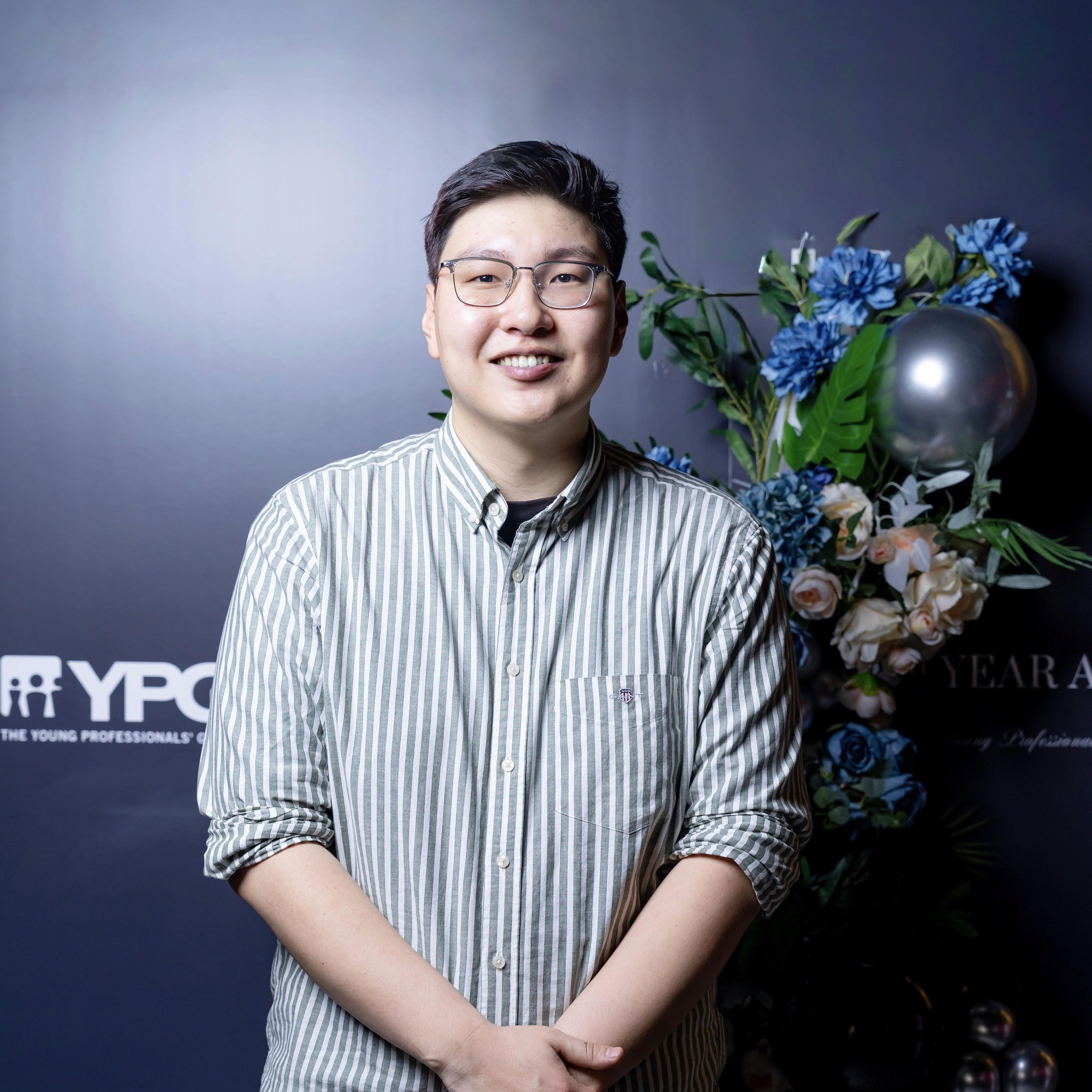 man in black suit jacket holding white ceramic mug