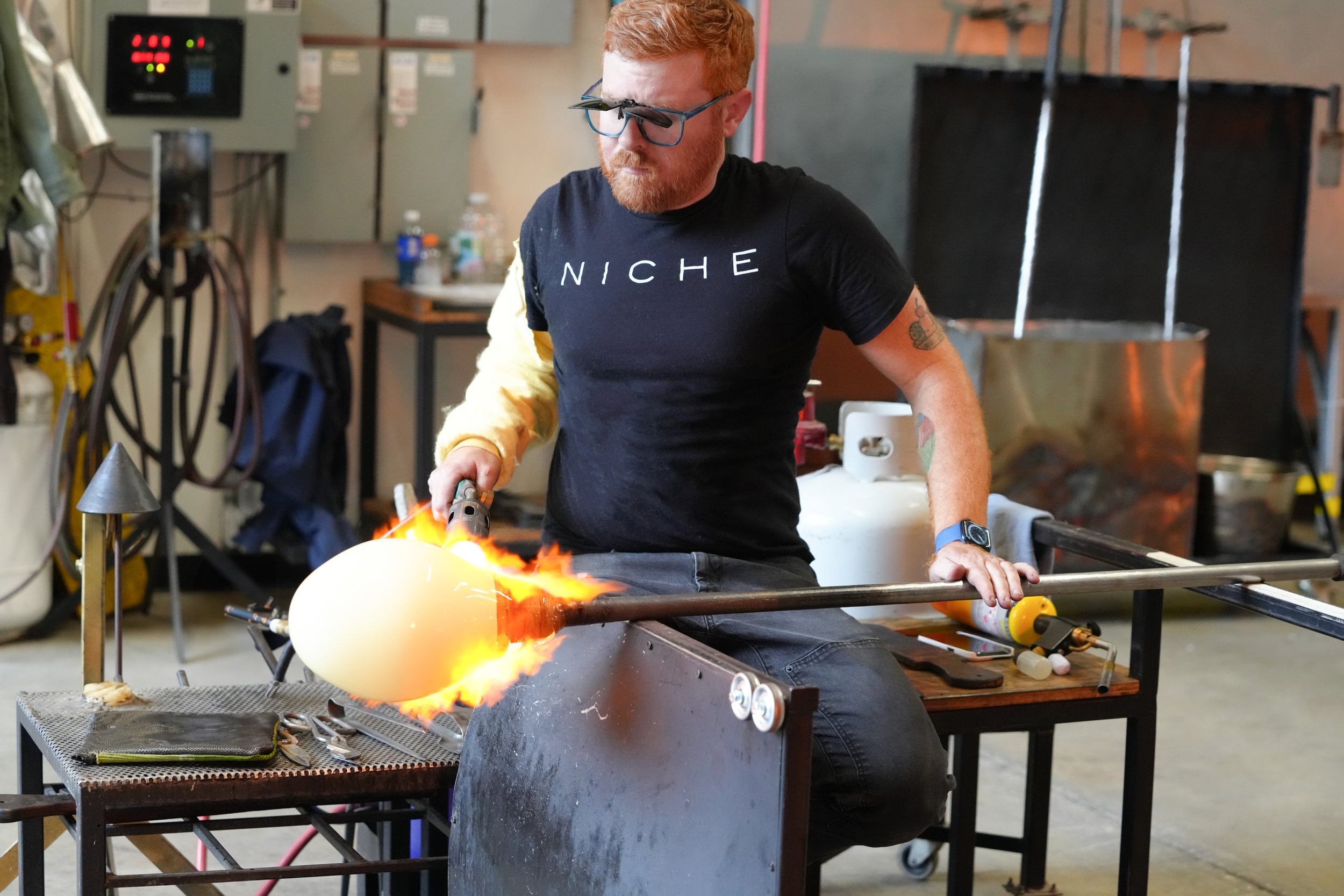 Niche Modern glassblower handcrafting blown glass pendant light fixture for residential and hospitality lighting projects in British Columbia