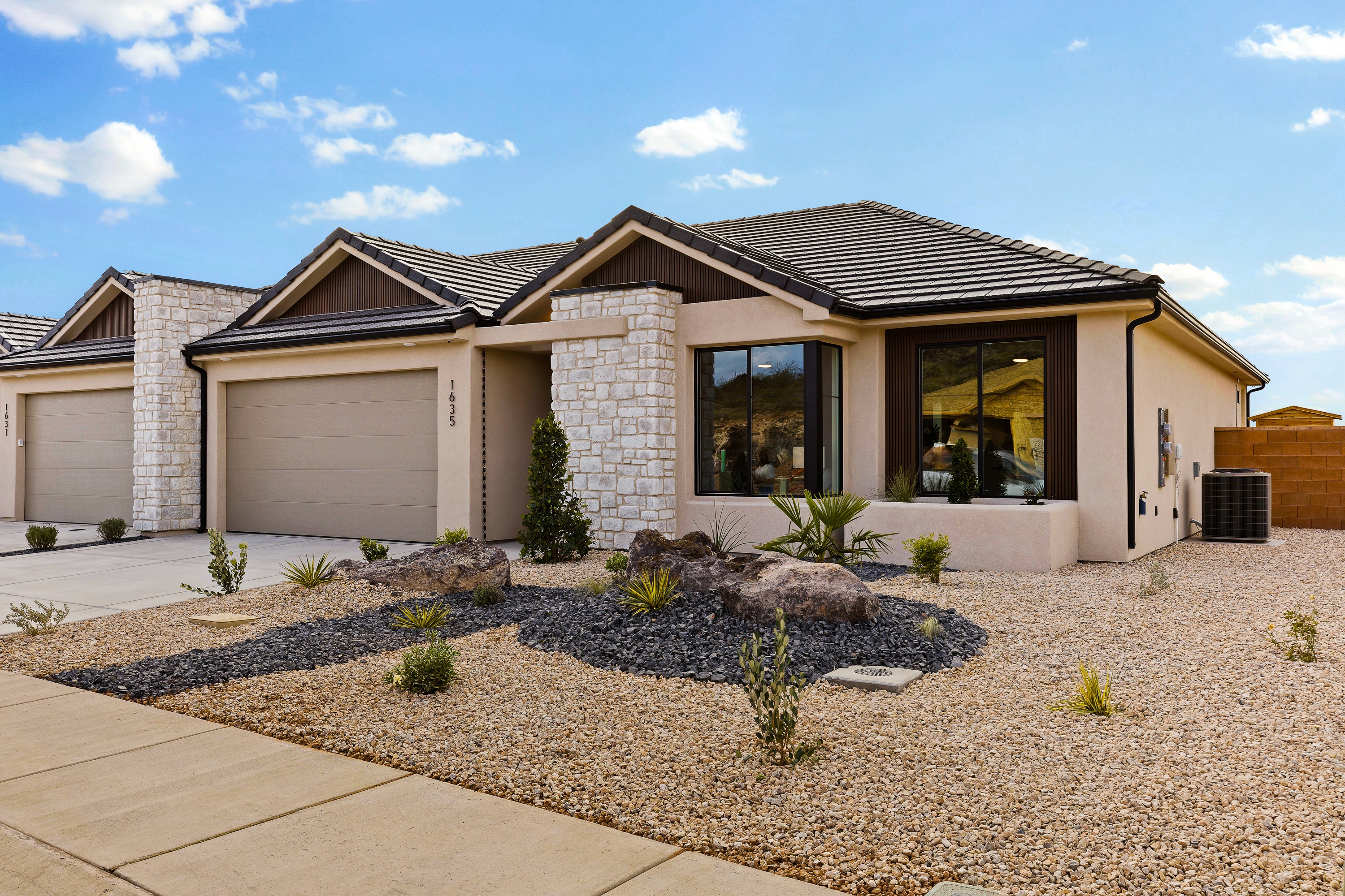 Front exterior of the BYSO House in Hurricane, Utah, showcasing the elevated entry and modern architectural details.