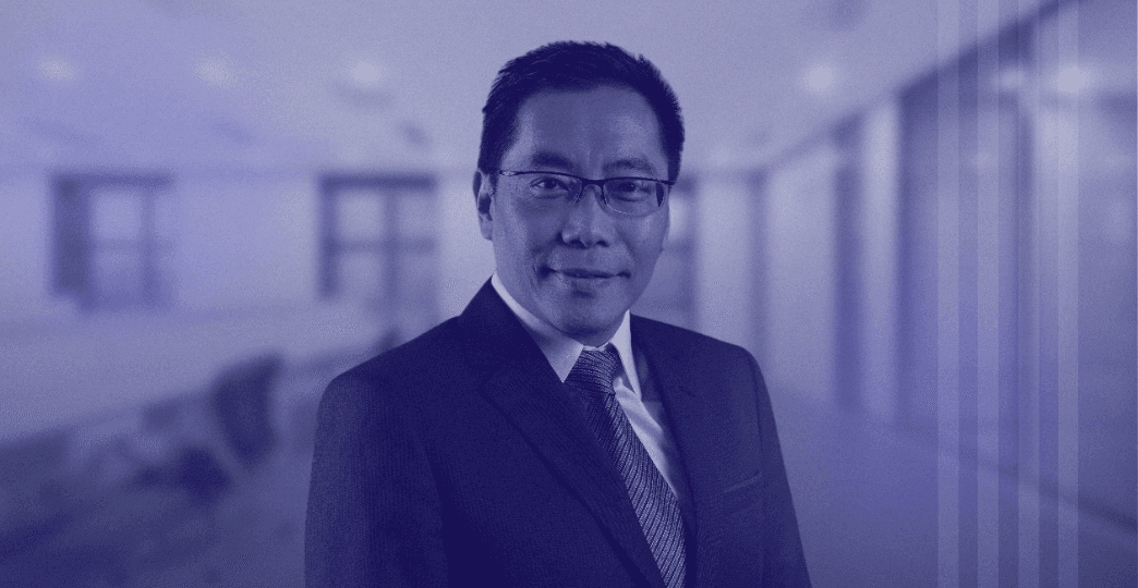 man in suit jacket sitting down