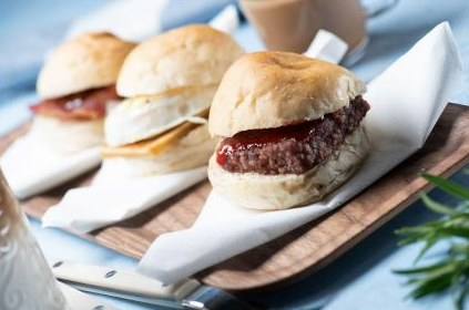 Fresh breakfast rolls on a board