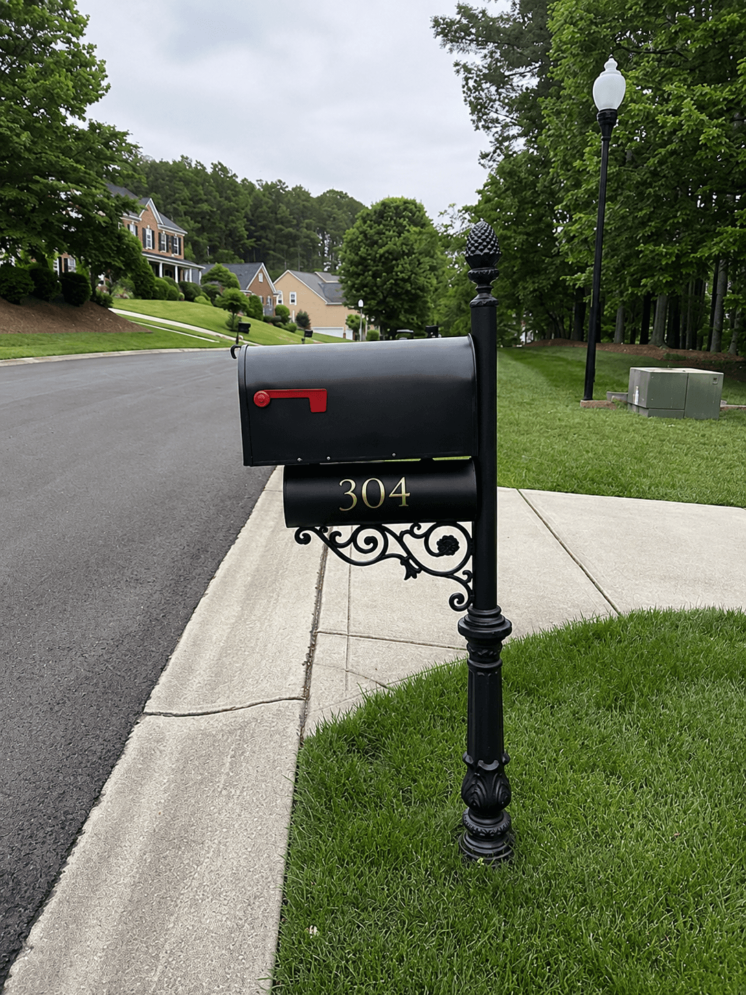 Restored black residential mailbox and post with custom gold vinyl address numbers