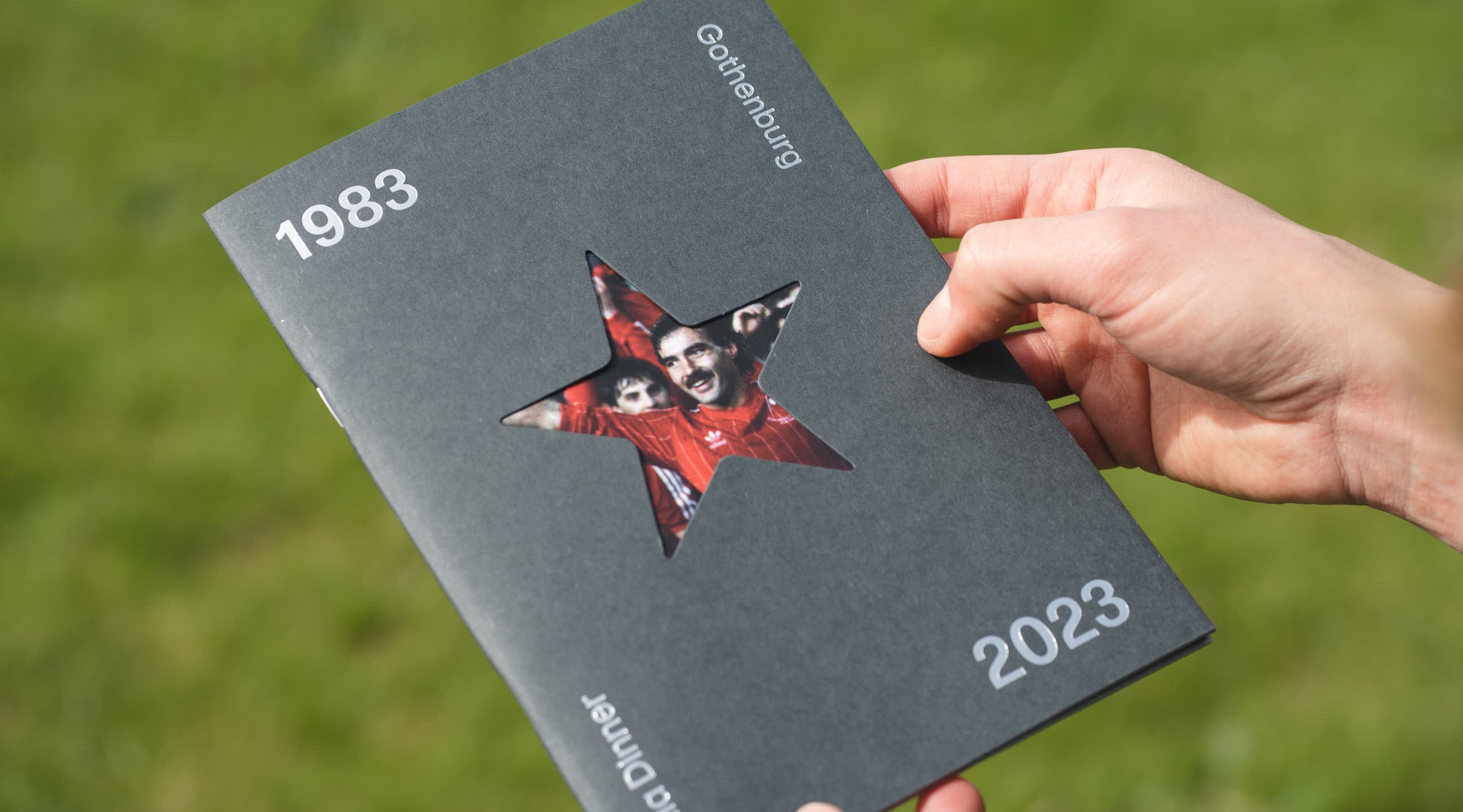 cover of a printed booklet with grass in background
