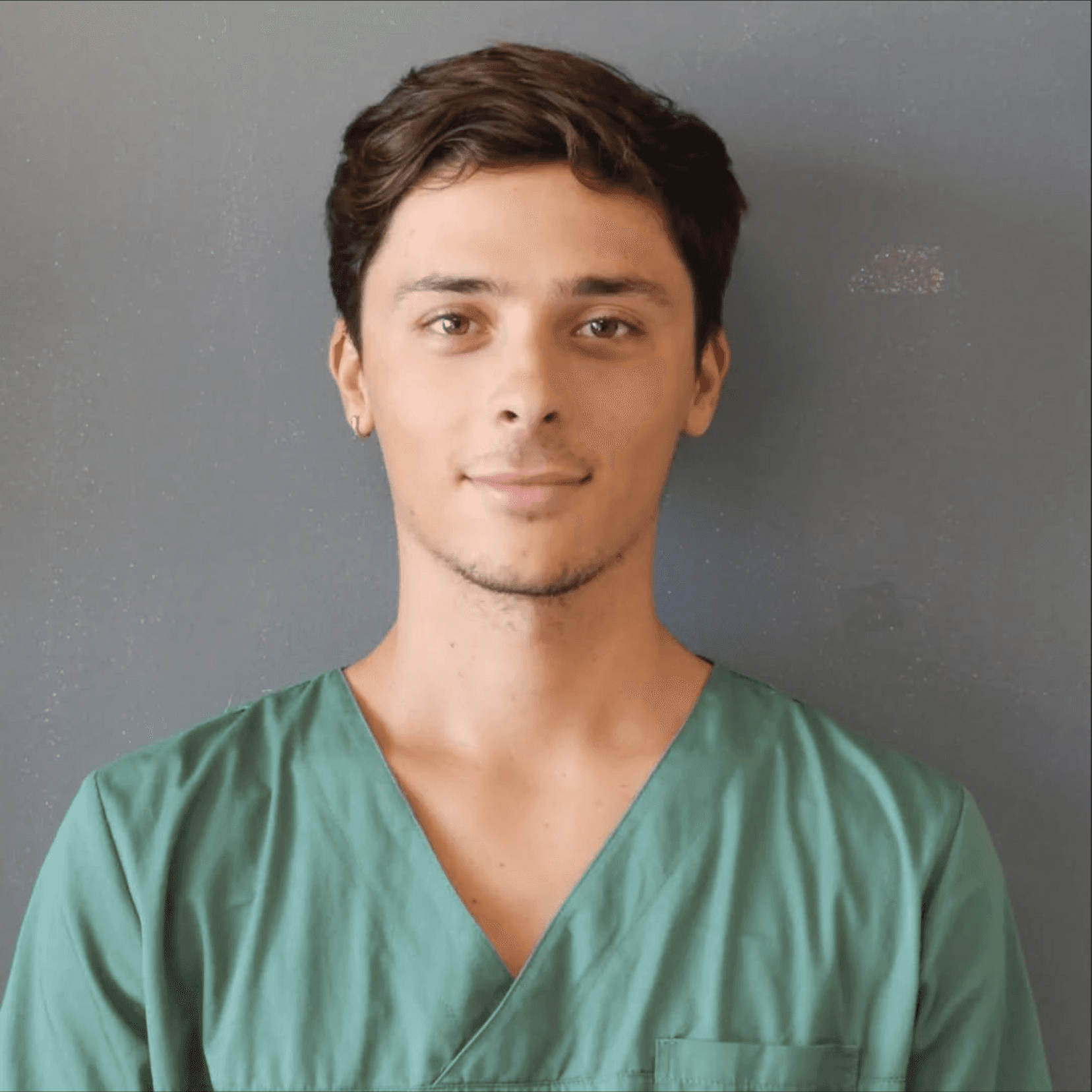 a man wearing a face mask sitting next to a dog