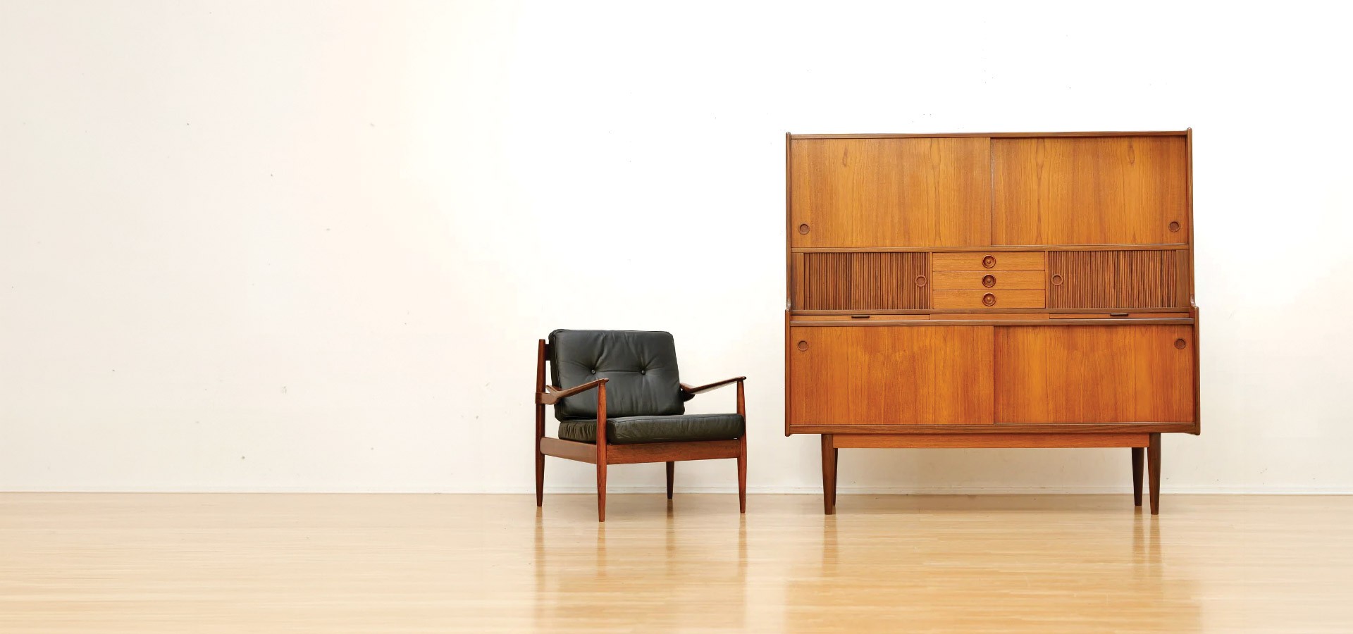 A modern armchair and cabinet.