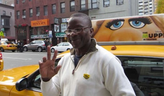 portrait of a taxi driver on the driver's side of his cab