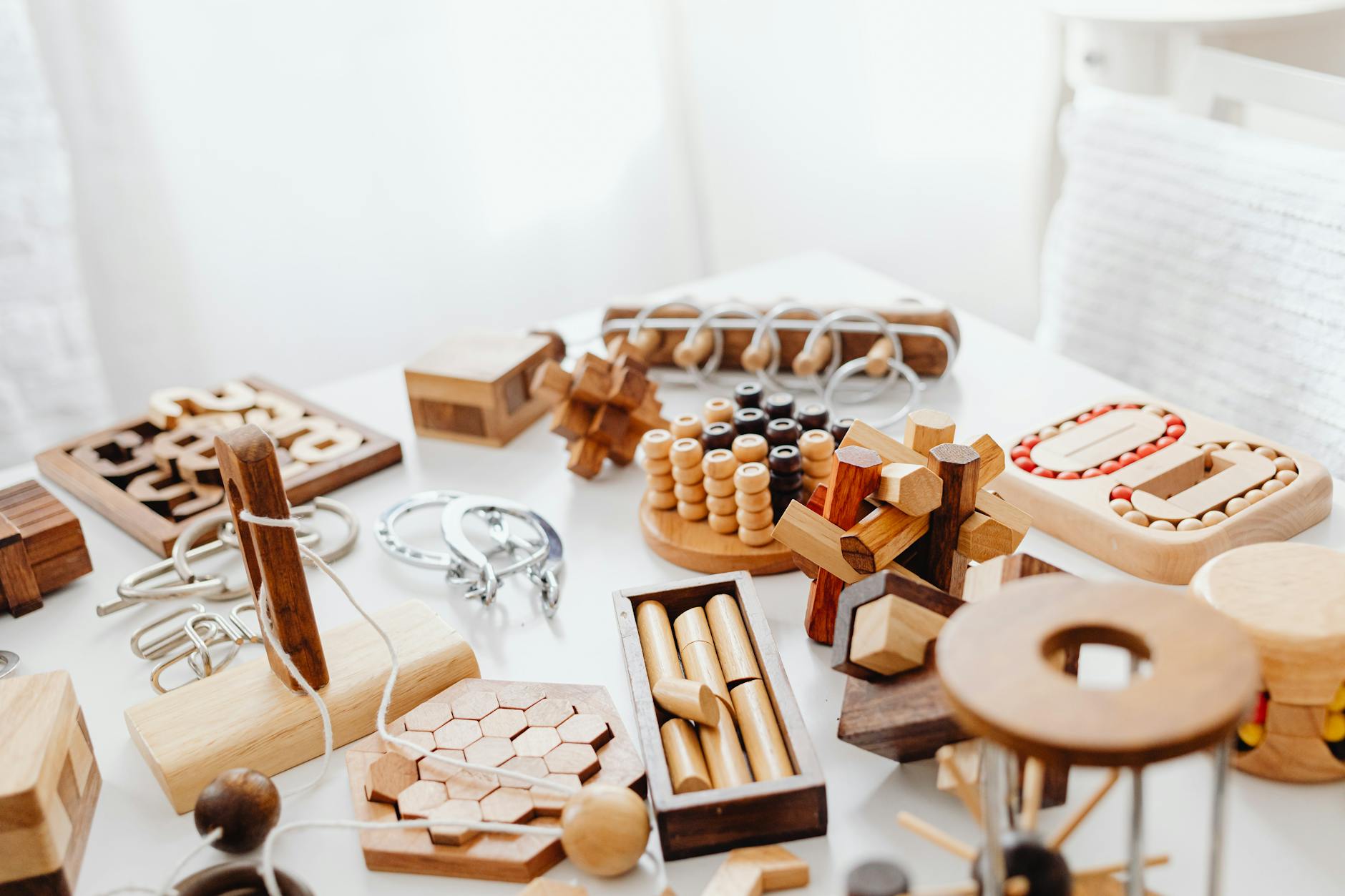 Close-up of wooden puzzle blocks being assembled by children during a group problem-solving activity.