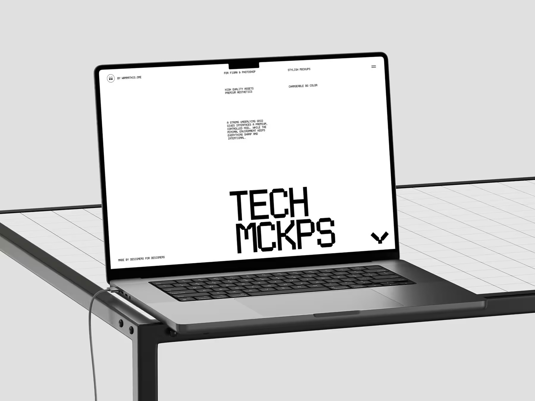 Laptop on a glass desk showing a black and white website
