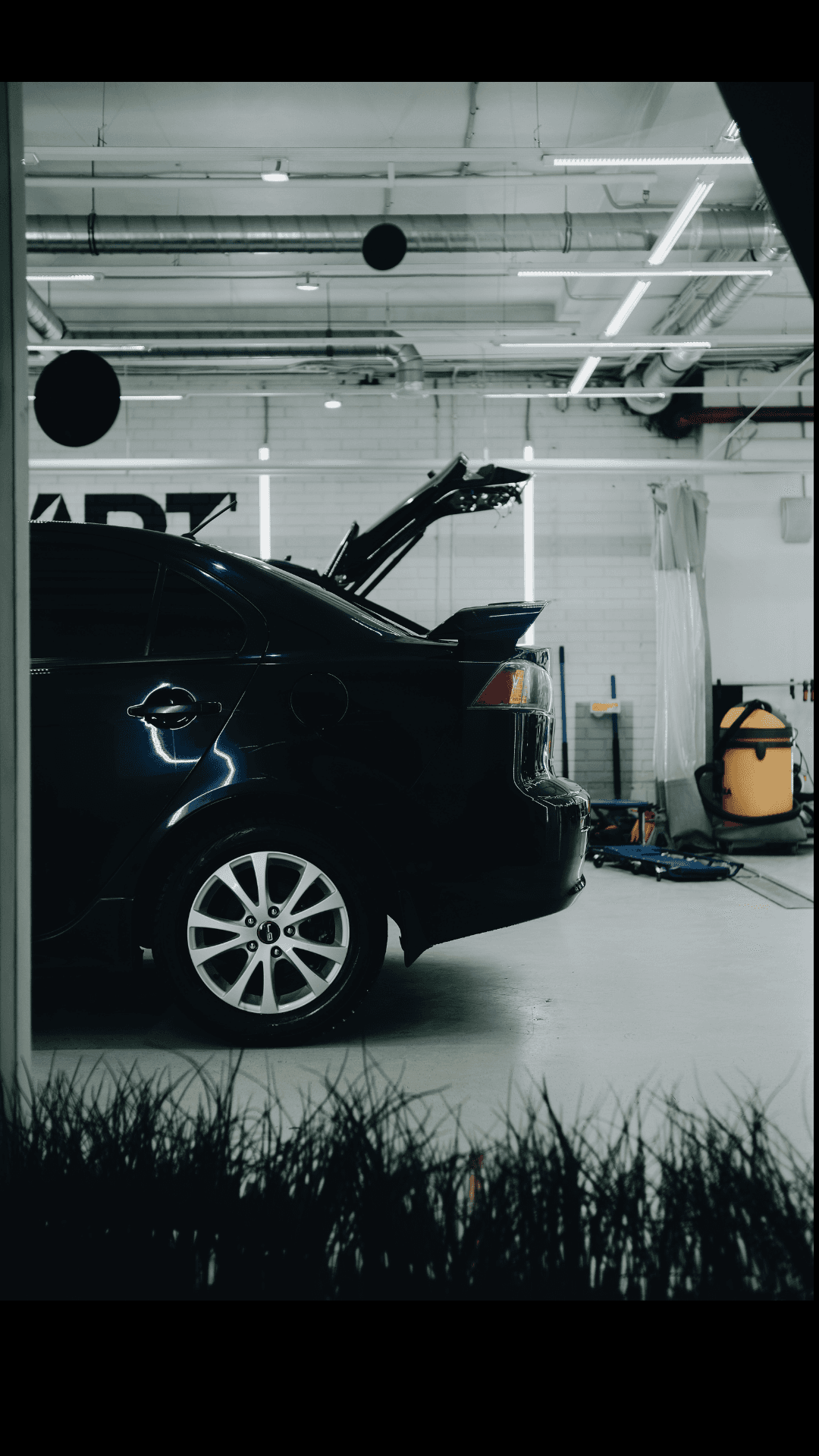 Collection of luxury sports cars displayed in modern rental showroom