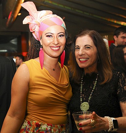 portrait of two women, one dressed in yellow and one dressed in black
