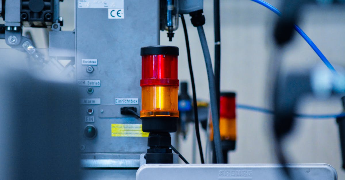 Detailed view of automated machinery with warning signals in an industrial setting.