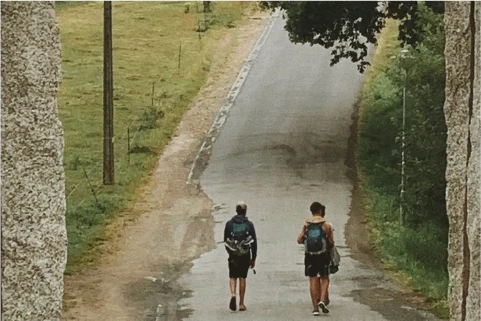 man and woman walking on concrete pathway