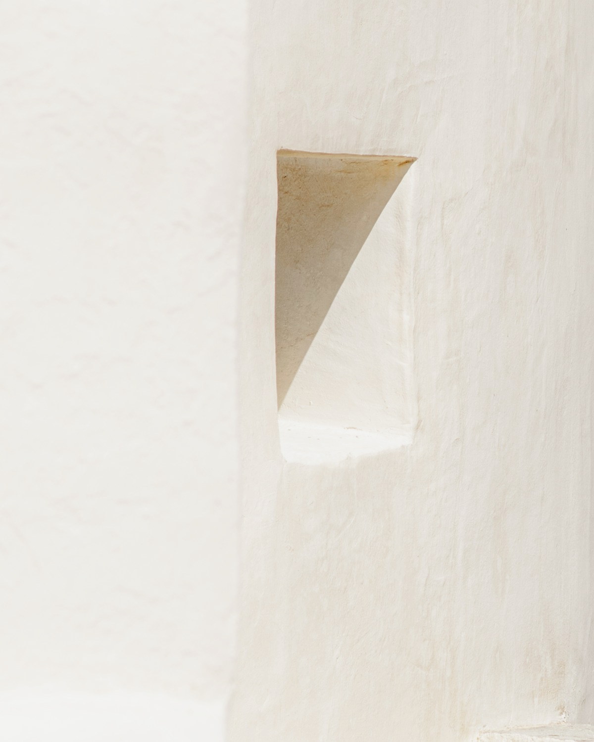 Hearth Wall Light in raw plaster, photographed against paper