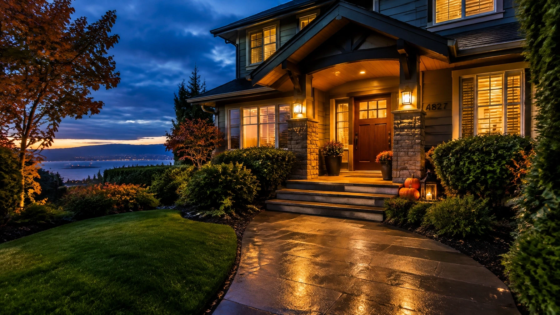 A warmly lit Vancouver-area home with a clear, welcoming walkway and tasteful Halloween decorations set safely aside