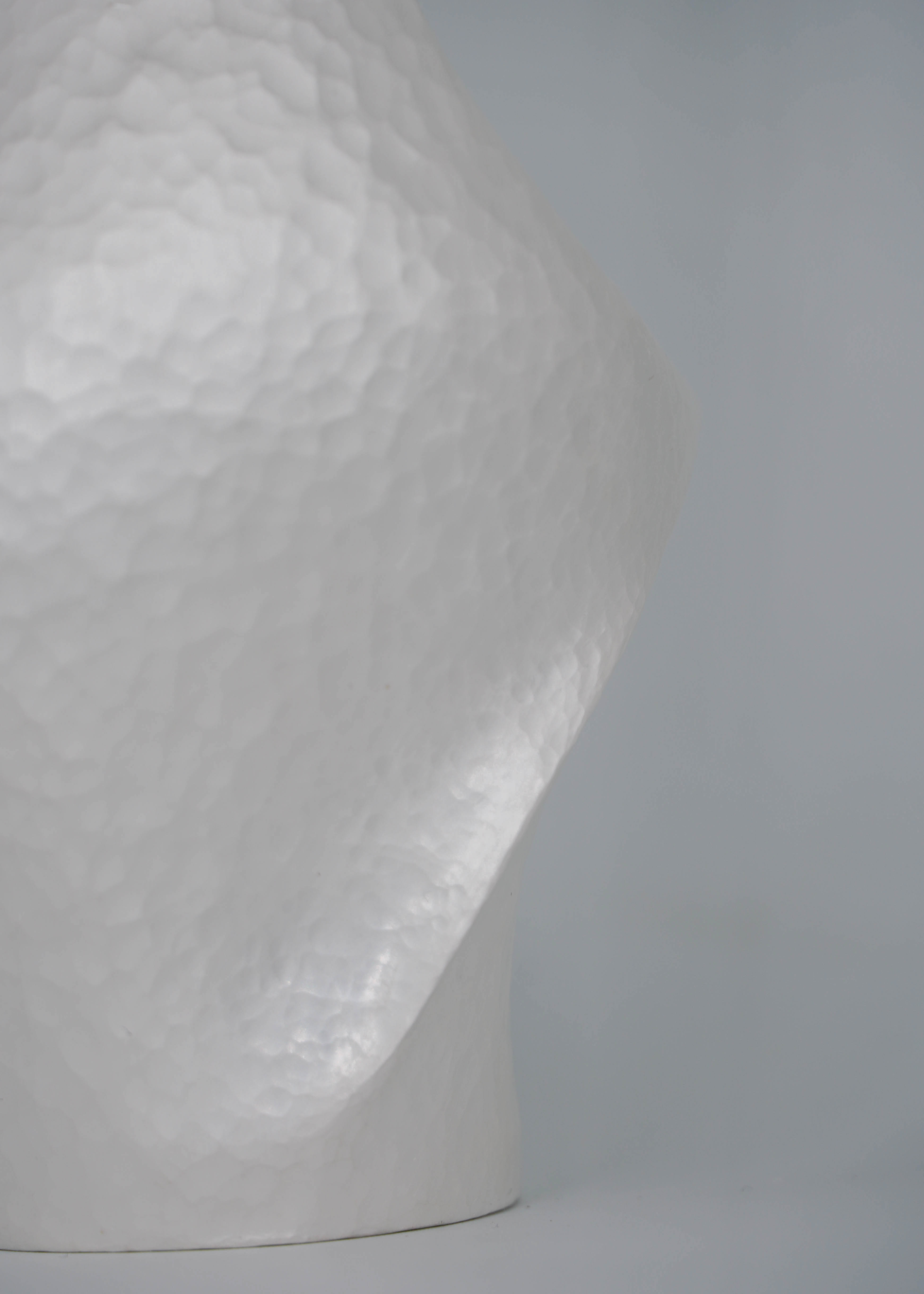 Close-up of Constrict by Yuxin Song, hand-forged fine silver vase. Contemporary silversmithing and metalwork by artist Yuxin Song