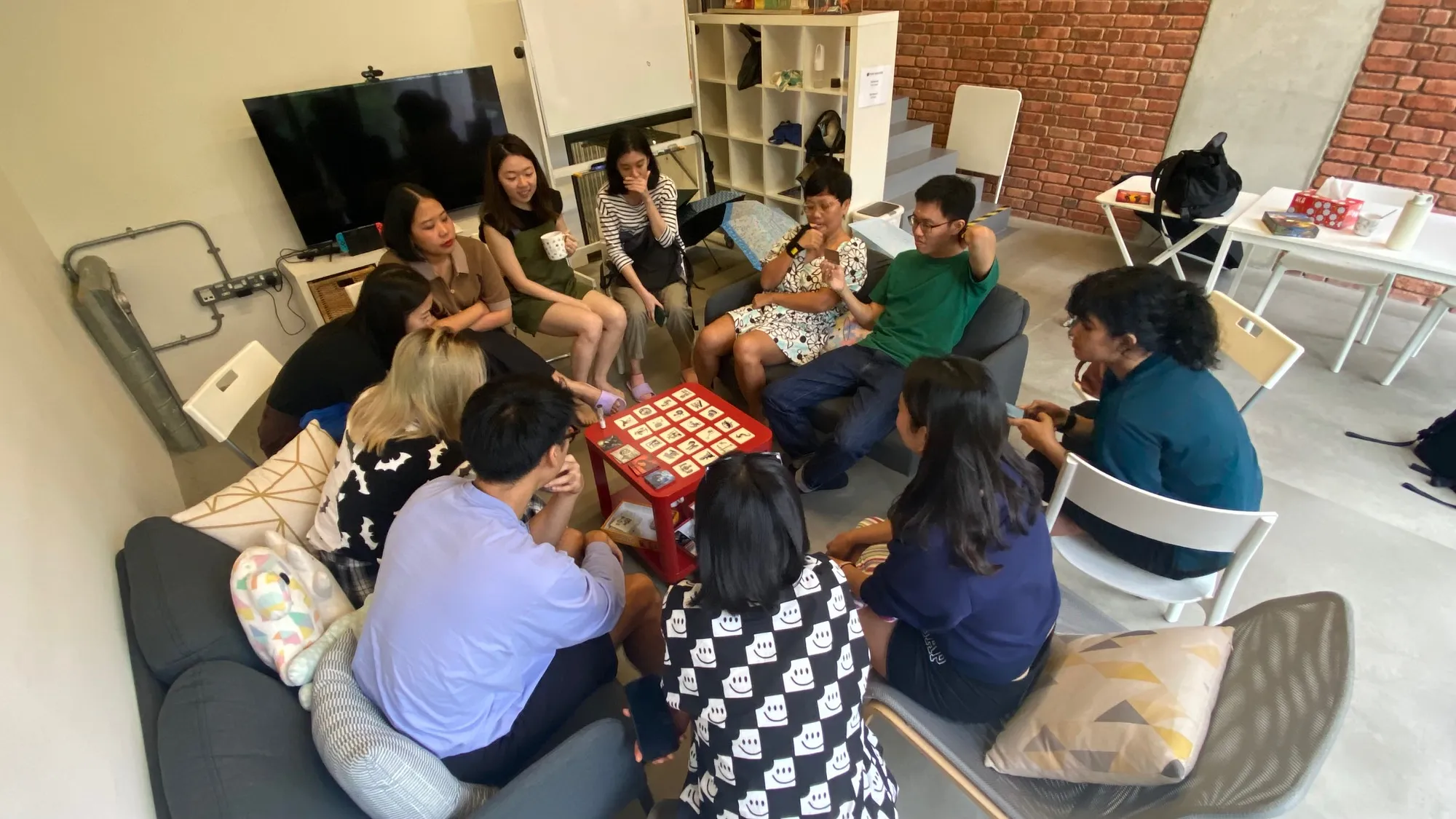 A top-down view of a group of people seated around a small table