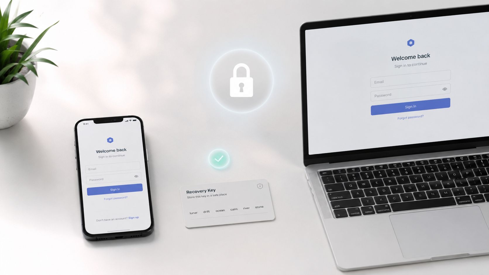A smartphone and laptop display sign-in pages with a physical recovery key card placed in between.