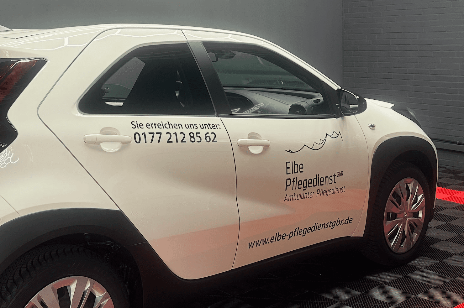 a small car with a red bull painted on it