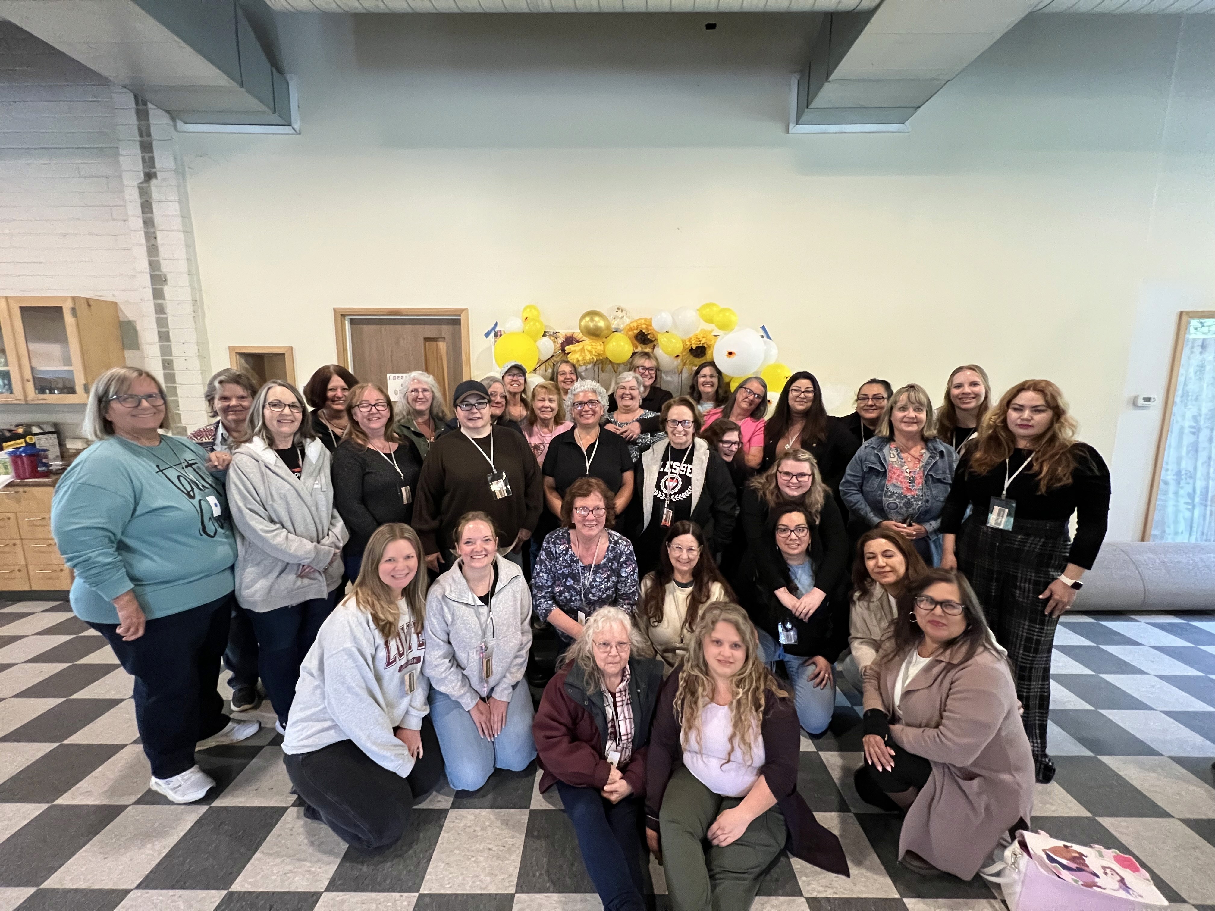 three woman holding each other and smiling while taking a photo