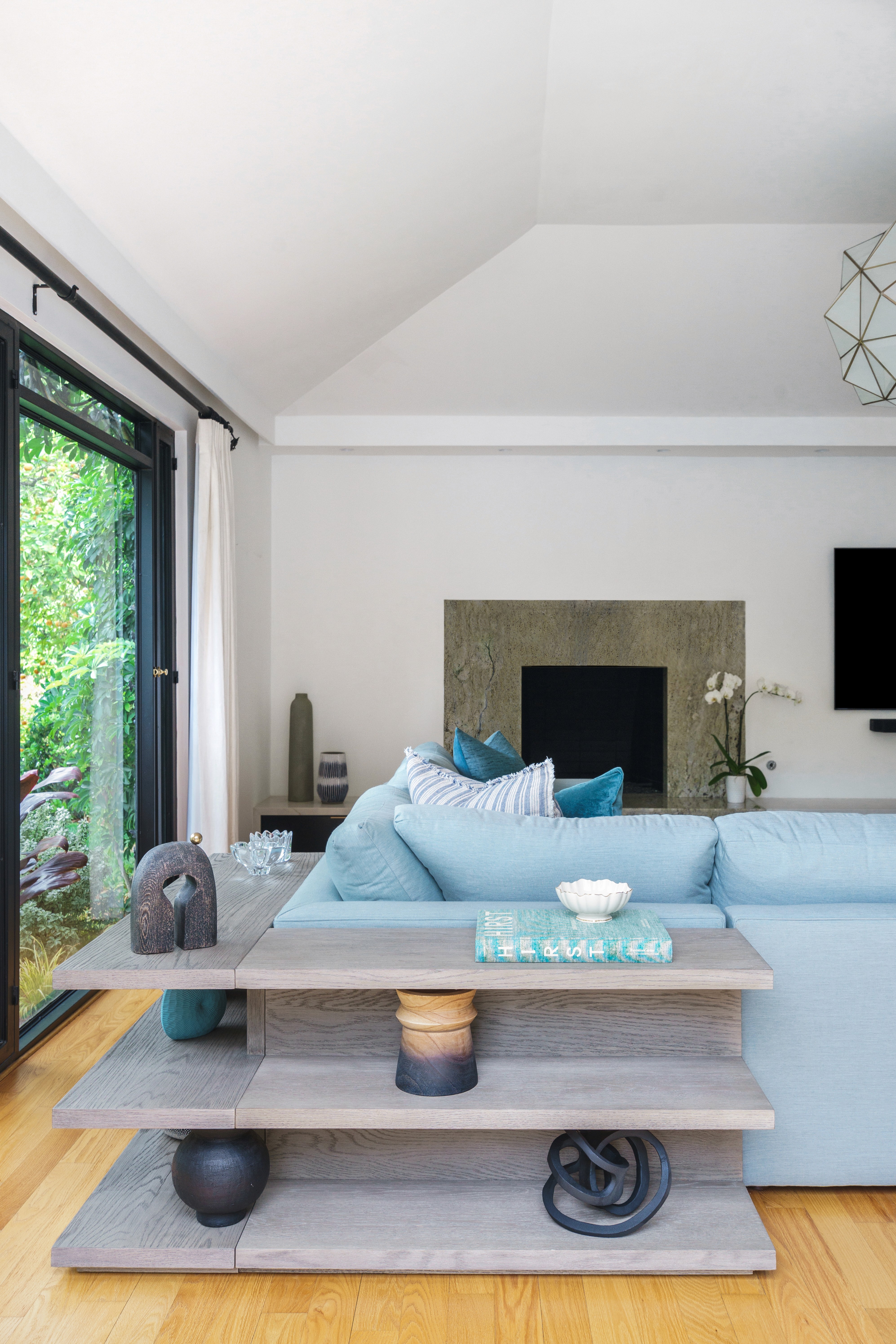 This beautifully landscaped outdoor space features a cozy patio, stylish dining set, and an eight-person wooden table, perfect for relaxation and entertaining