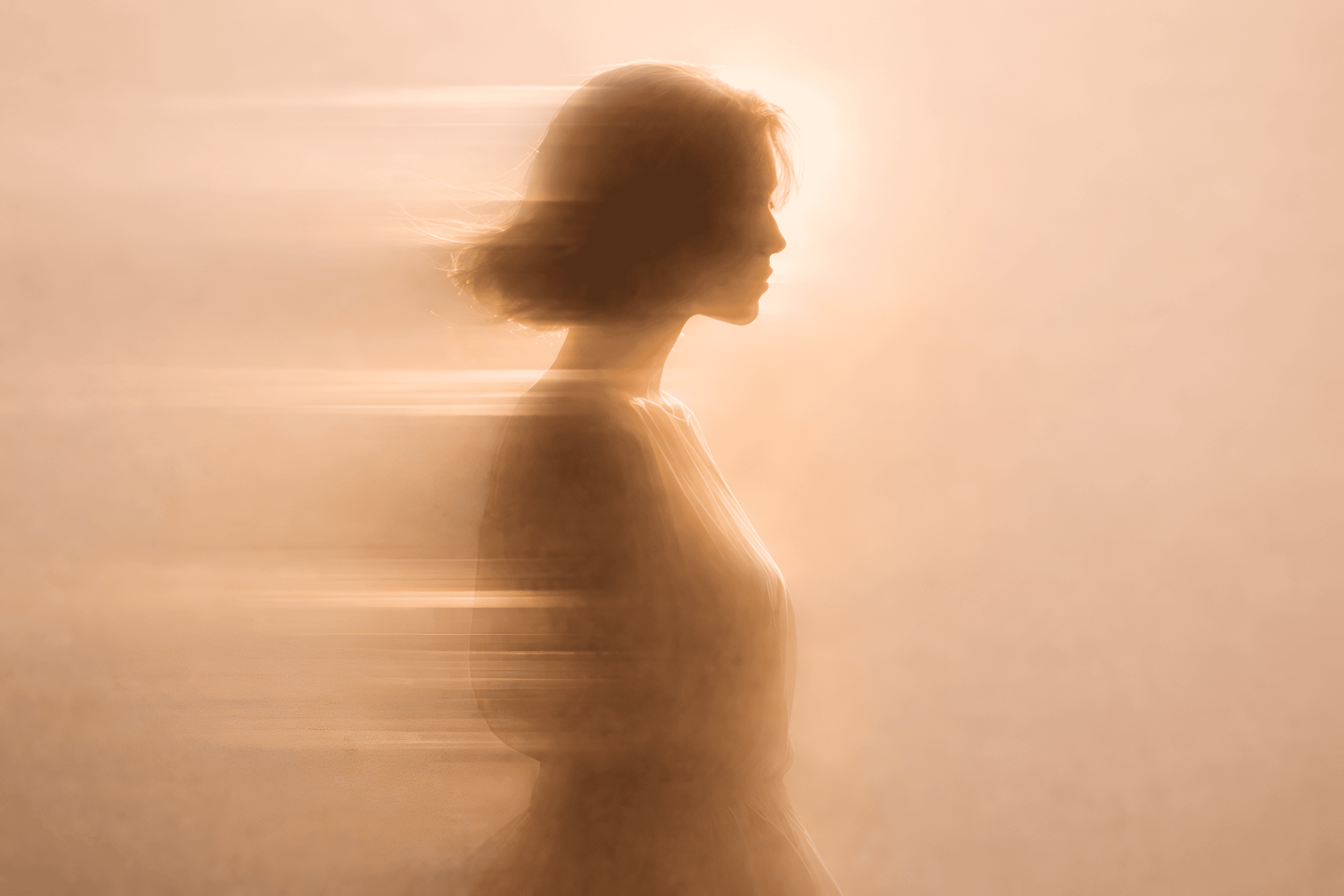 Side profile of a person with motion blur trailing behind, creating a layered effect against a light background.