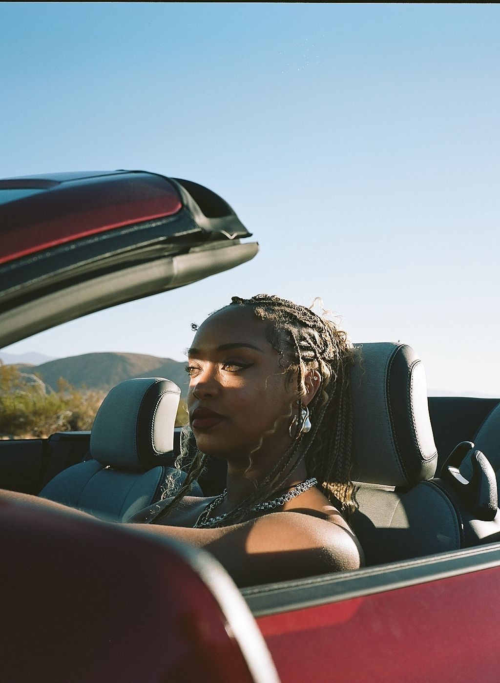 Woman with red hair covering mouth with hair