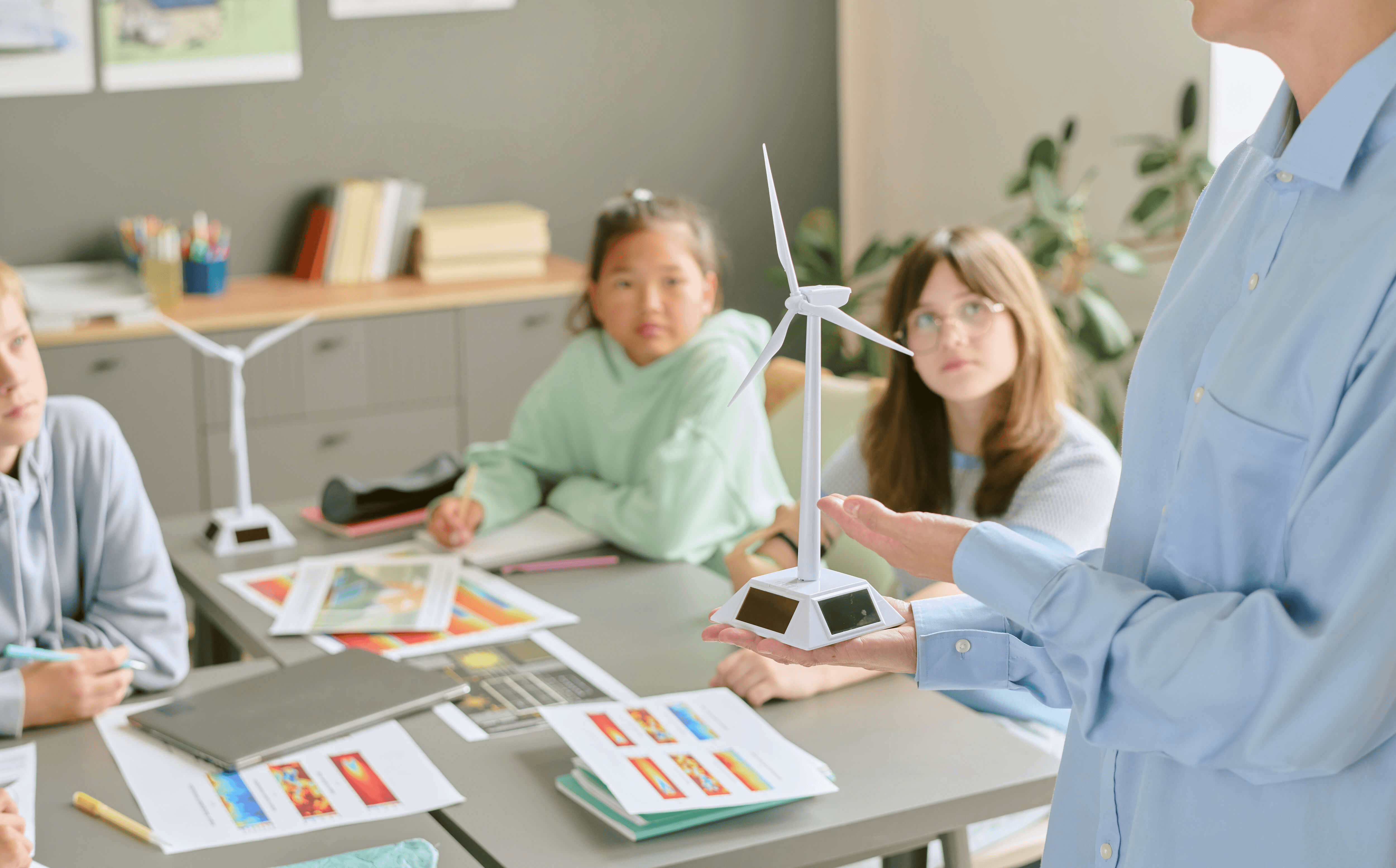 A mother and her daughter are working together on a laptop, focusing on homework