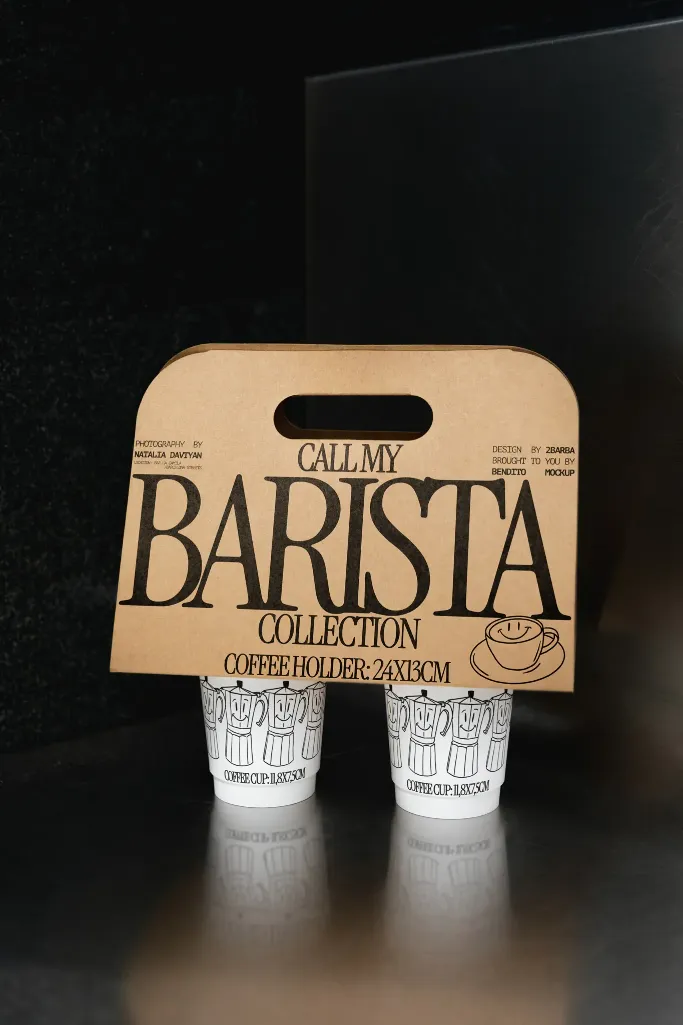Barista collection coffee cup holder with vintage-inspired typography on a brown paperboard, holding two coffee cups with colorful Moka pot illustrations; dimensions listed as 24x13cm.