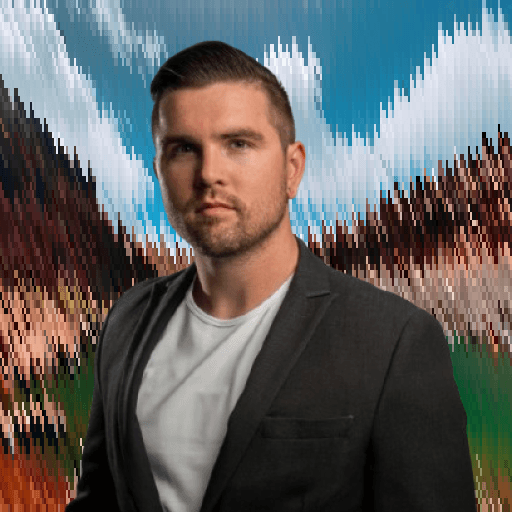 Professional headshot of a man in formal attire against an outdoor scenic background.