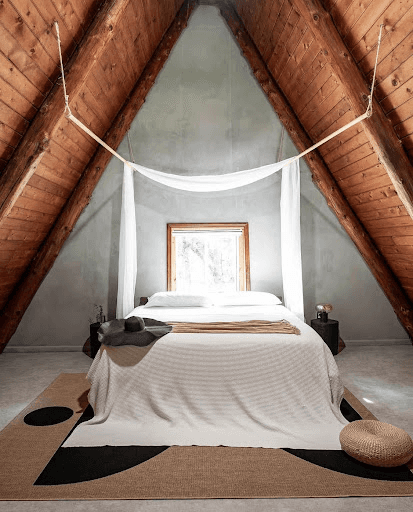 A silhouette of a person standing amidst vibrant swirling colors of teal and orange.