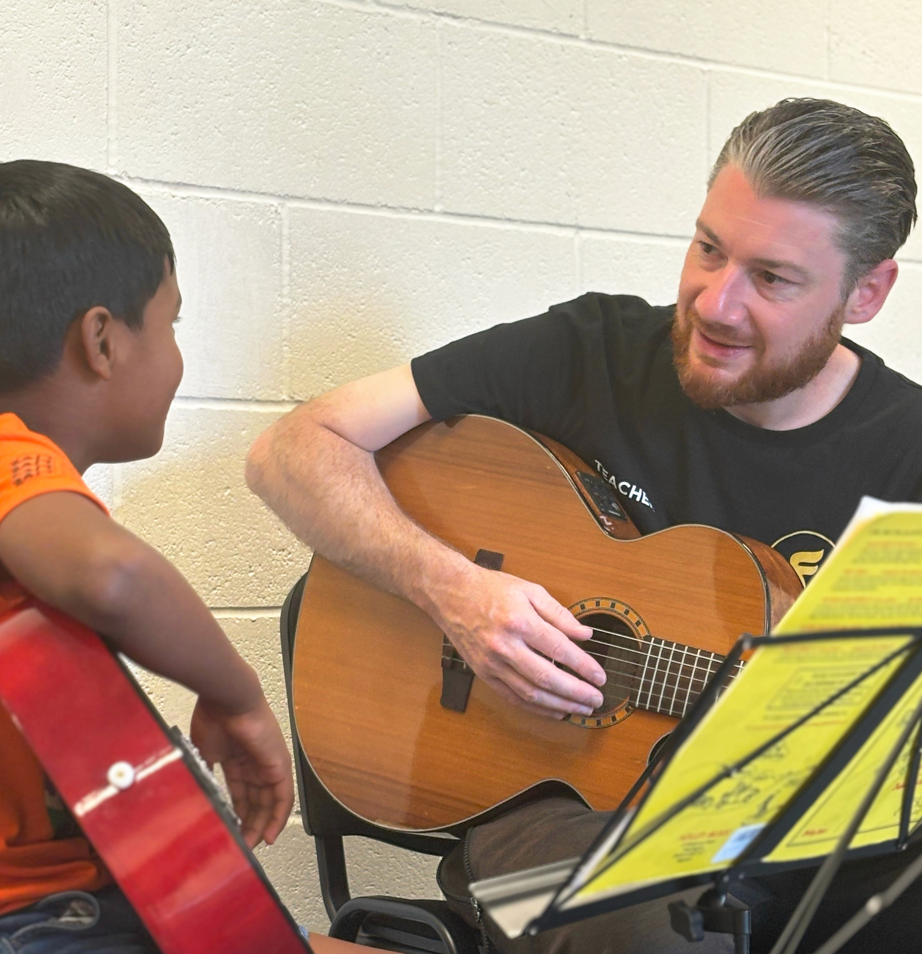 A teacher instructing a student  about popular chords