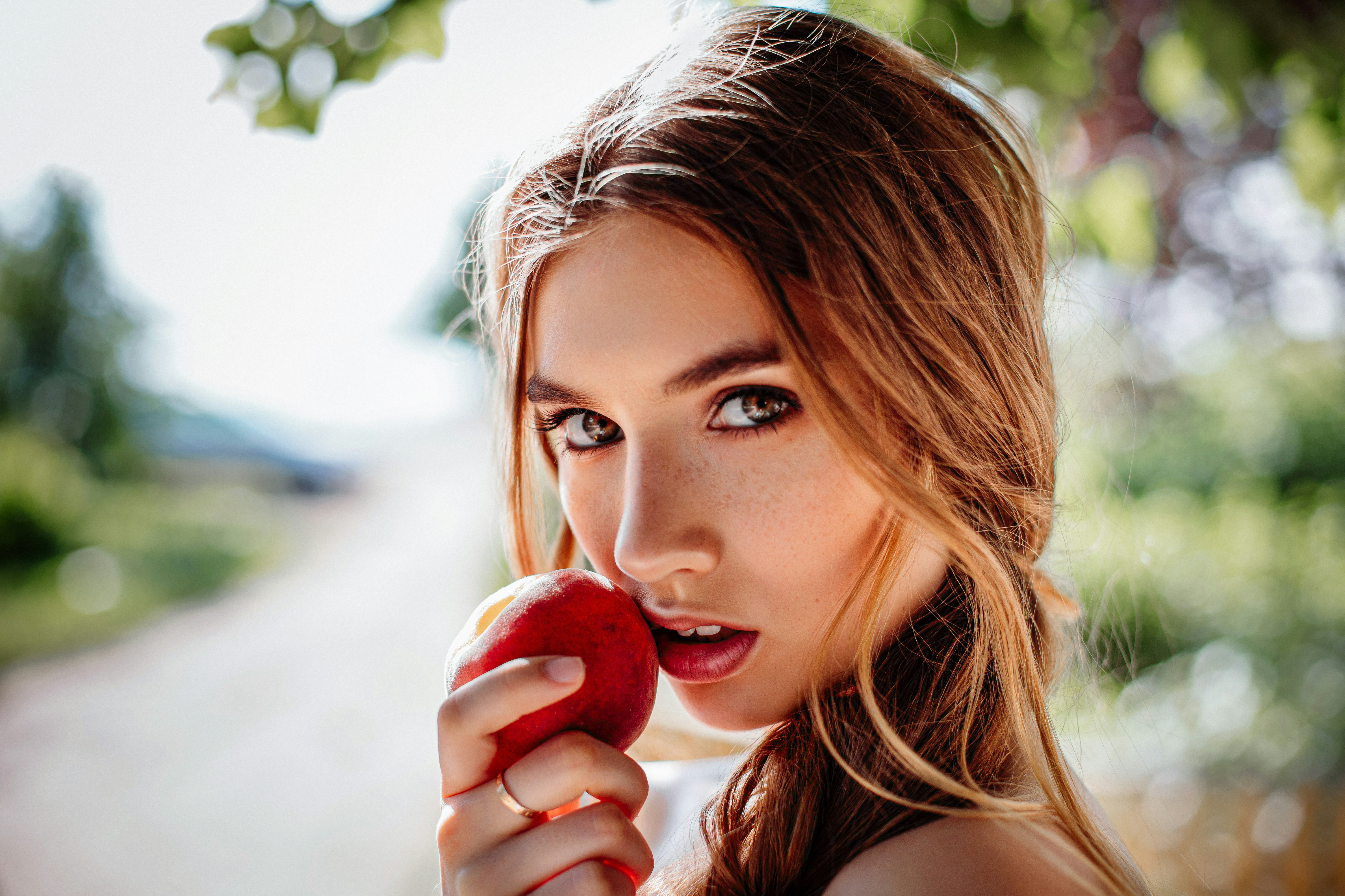 woman eating an apple - Teen Skincare Routine