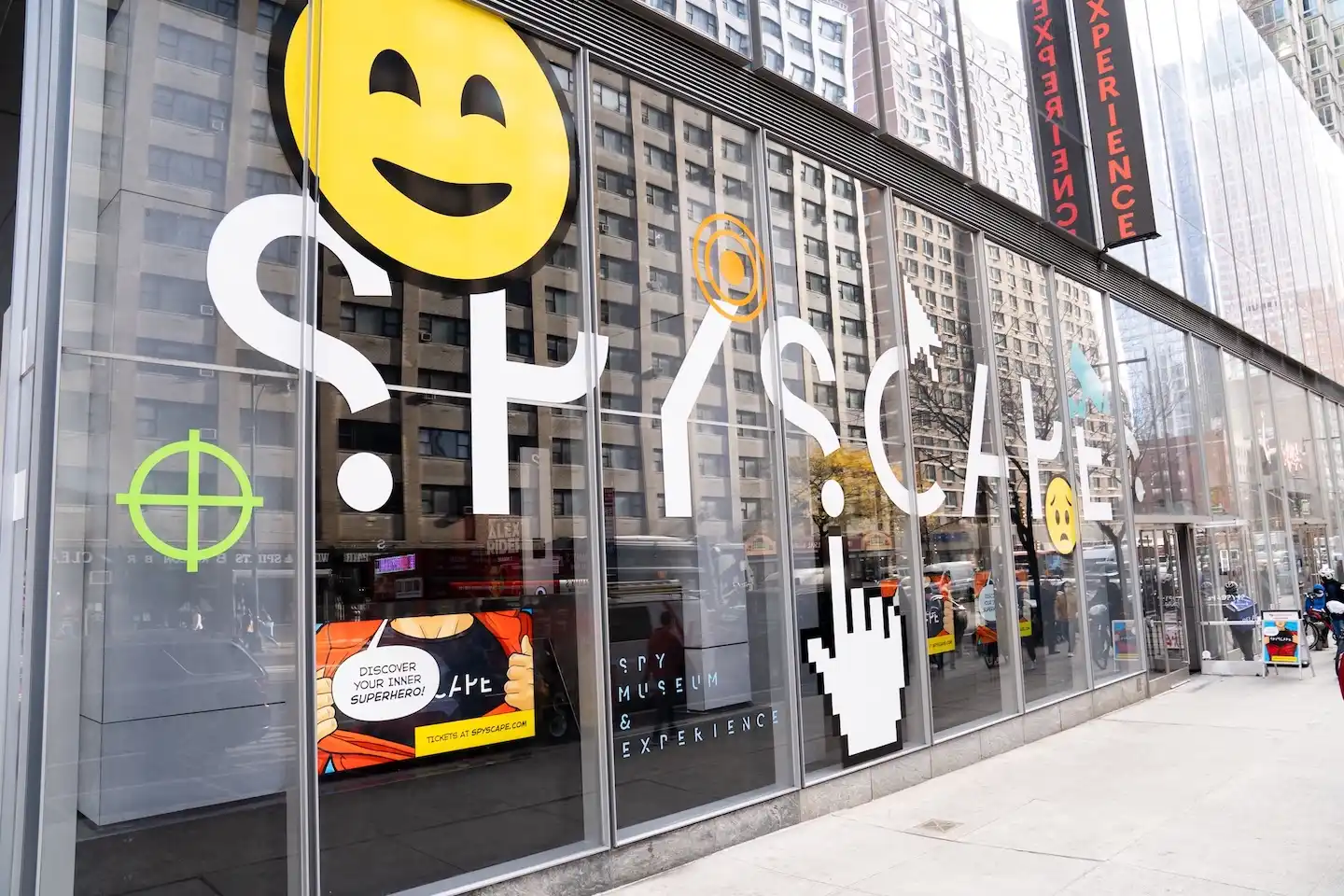  SPYSCAPE building exterior with large white logo and playful emoji-style graphics across the glass windows in New York City.