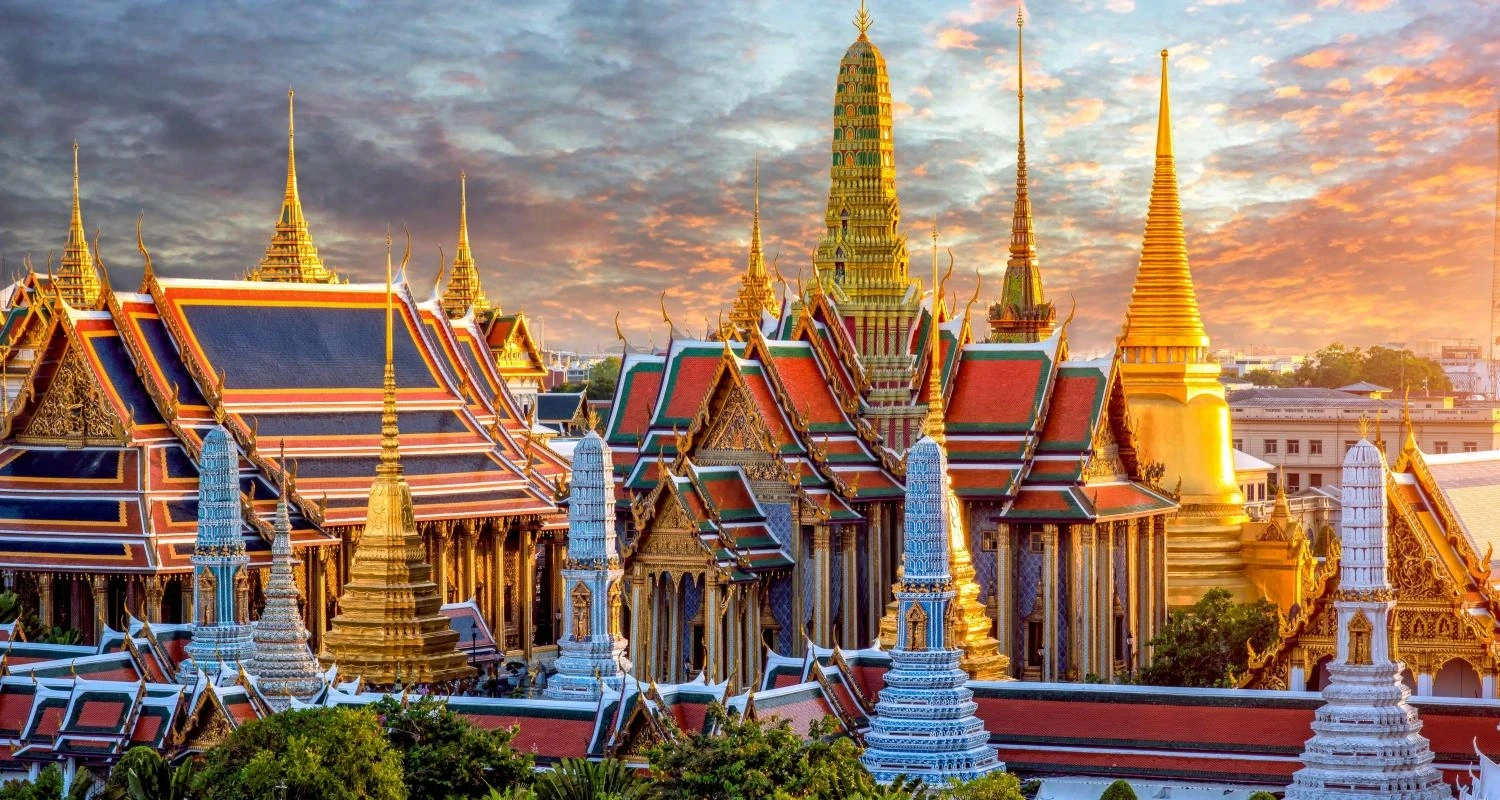 Grand Palace golden spires sunset.