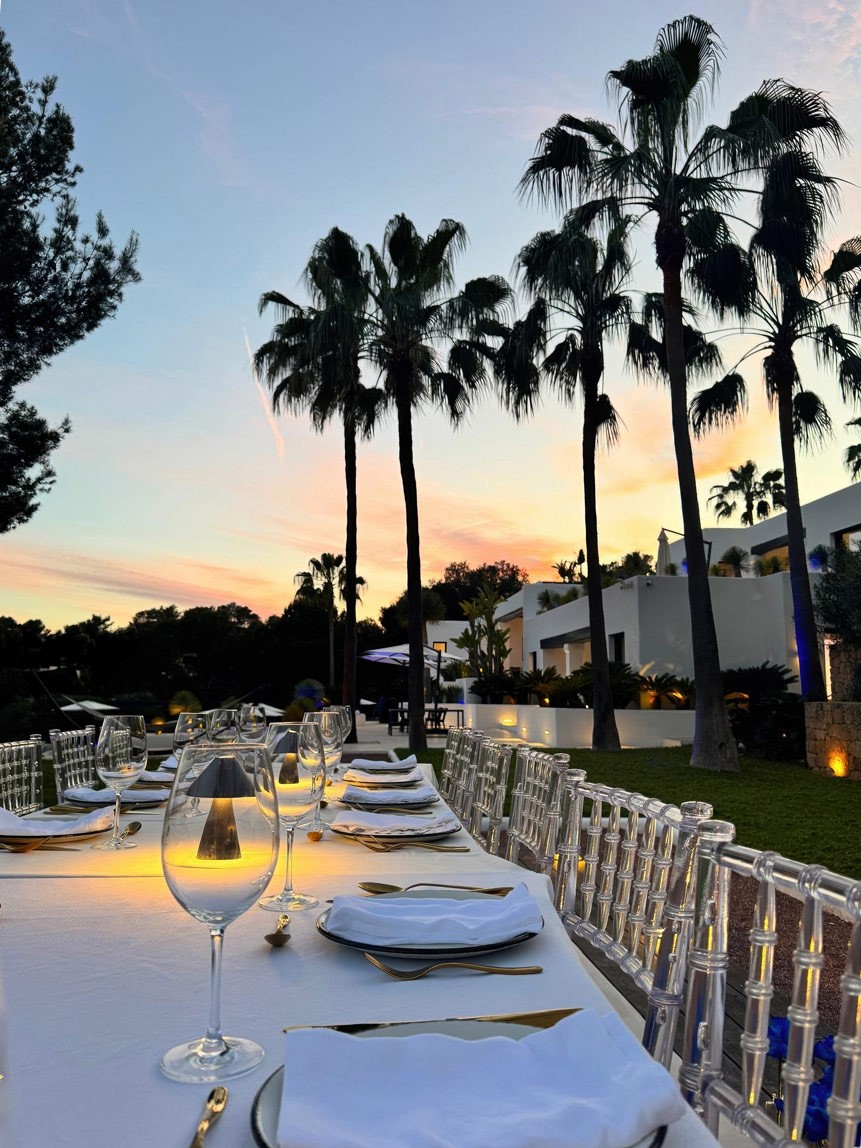 Elegant outdoor dining table with floral arrangements and candlelight at Can Nemo Ibiza during a private evening event.
