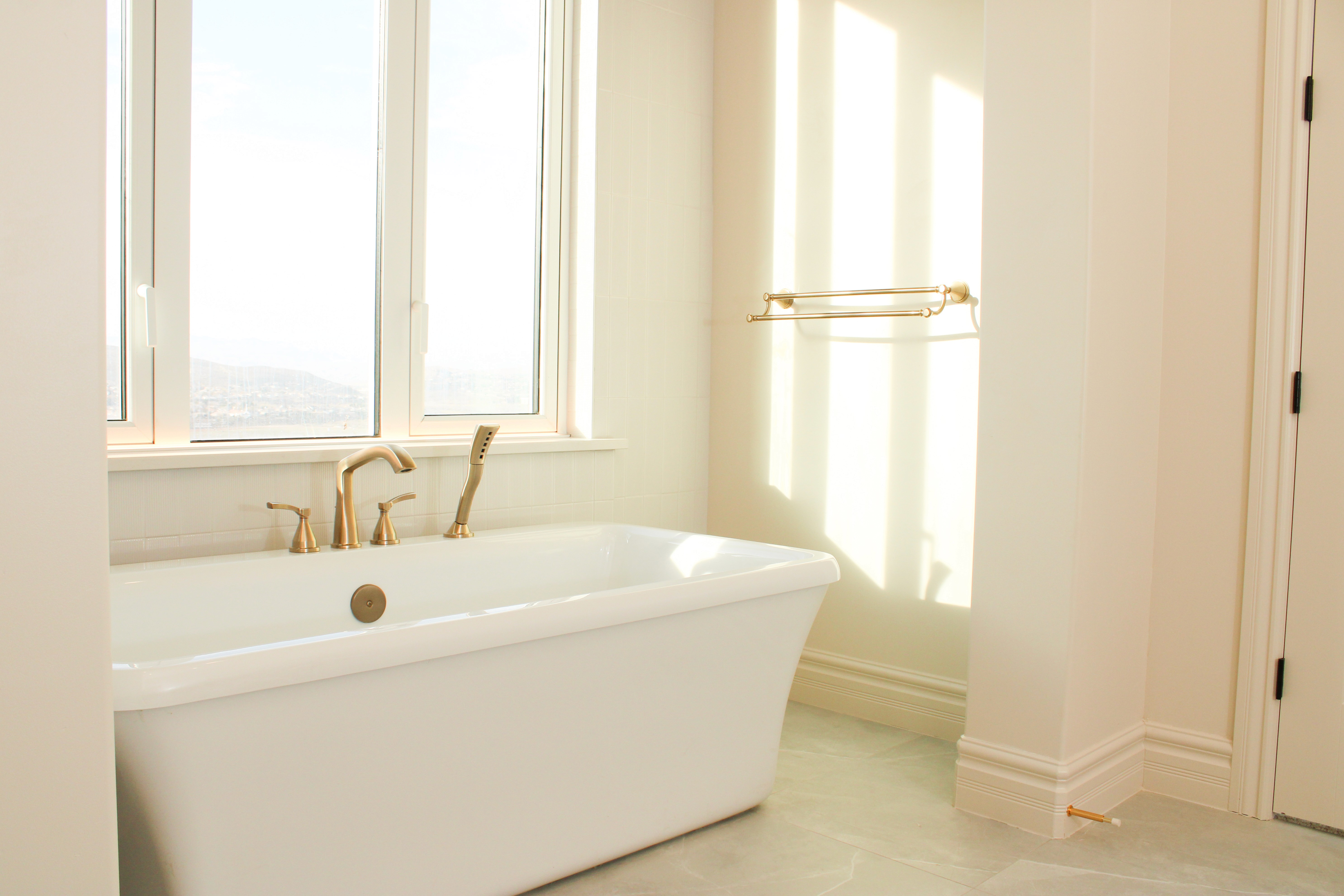 Master bathroom with freestanding tub and elegant tile in a custom home in St. George, Utah.