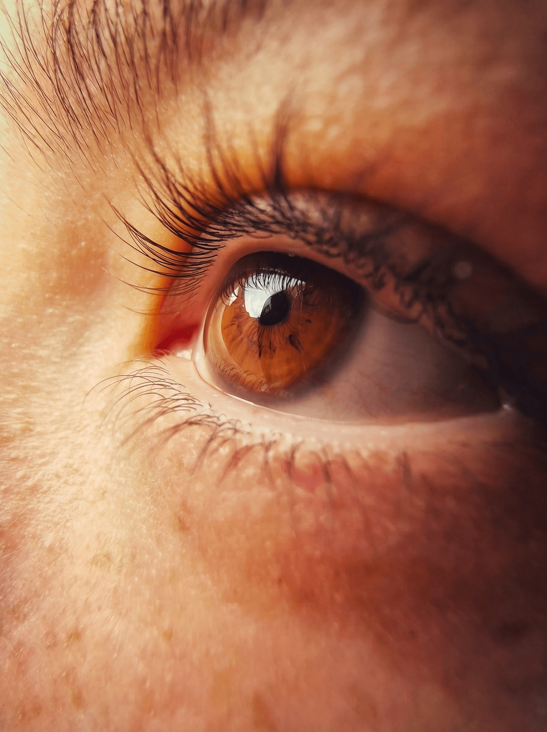 A person with locs pulling a yellow turtleneck over their face.