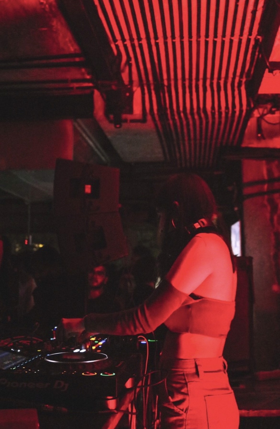 Two people talking on a rooftop at sunset