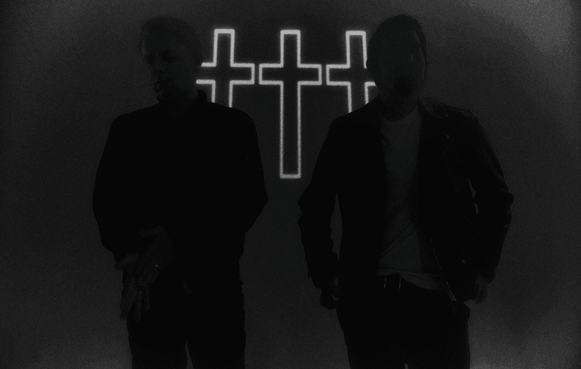 Crosses band portrait in silhouette in front of three illuminated crosses