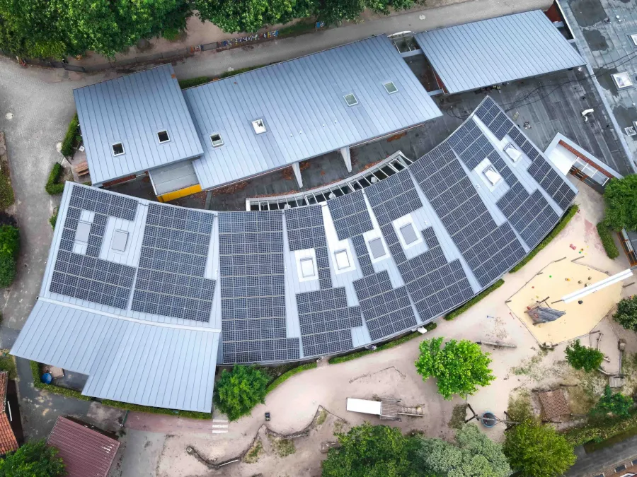 Dach mit Solaranlagen, Kindergarten, Spielplatz, Baumkronen