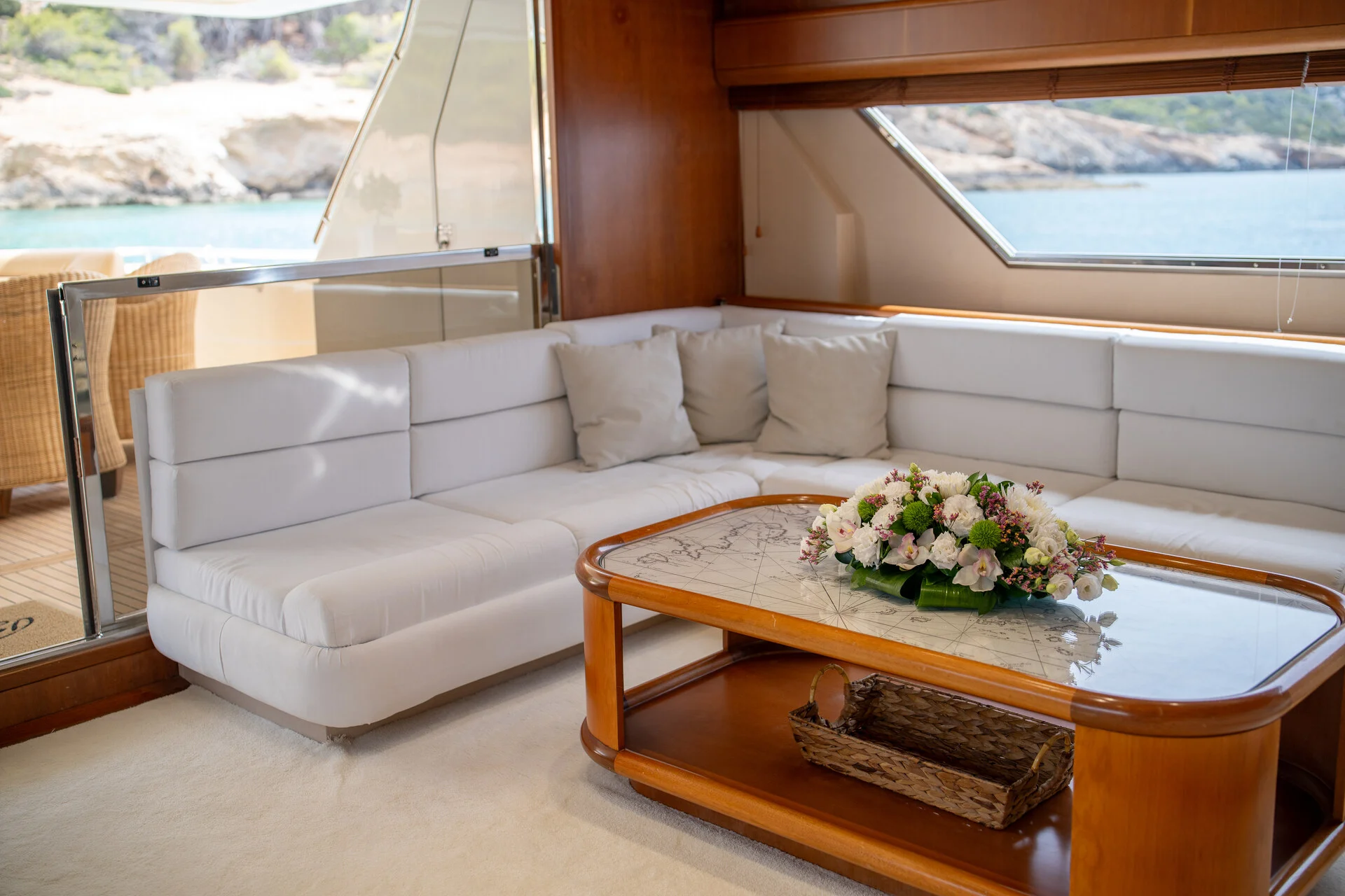 White Rock 36 speedboat with captain at helm cruising calm blue waters near Paros coastline with hills in background.
