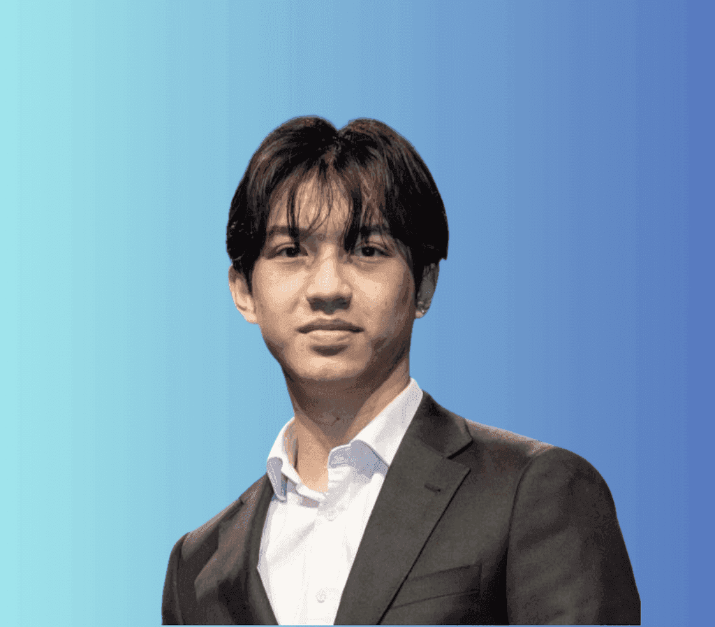 smirking woman wearing red and black checkered top and eyeglasses