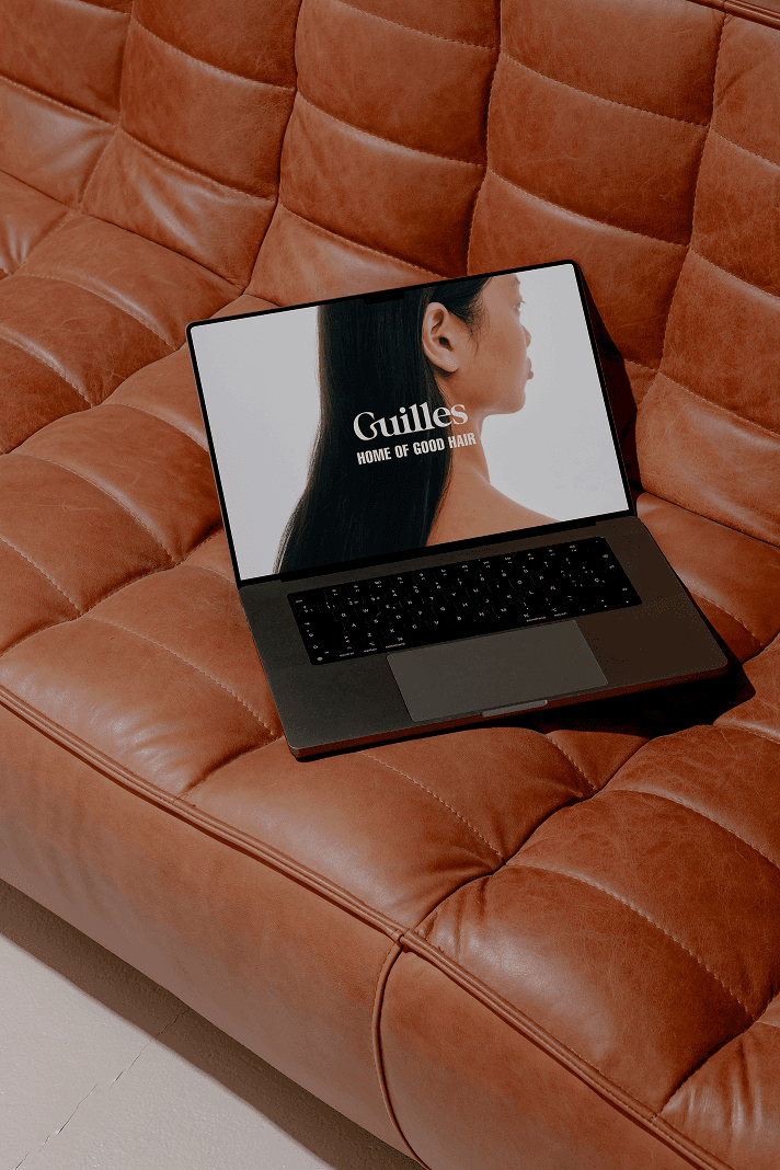 Branding image of a poster in Sydney for a luxury hair salon named Guilles based in Sydney, featuring sleek hair, the brand tagline ‘home of good hair’