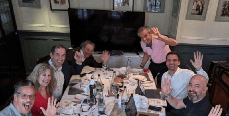Table with open book, tea and pillows spread around